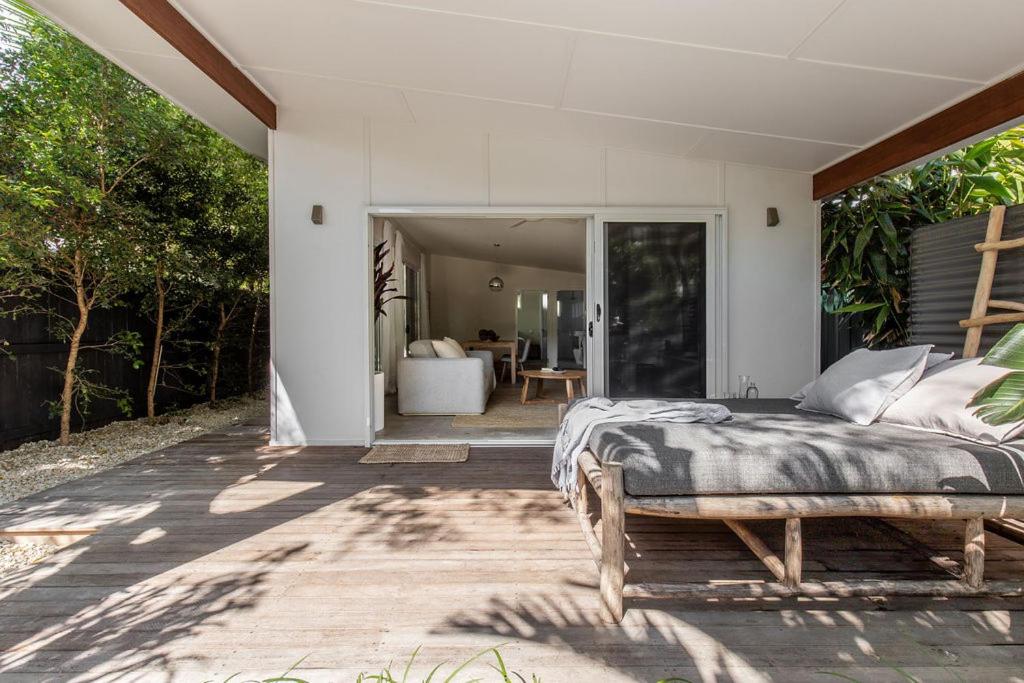 a bedroom with a bed on a patio at The Local House - Byron Bay in Byron Bay