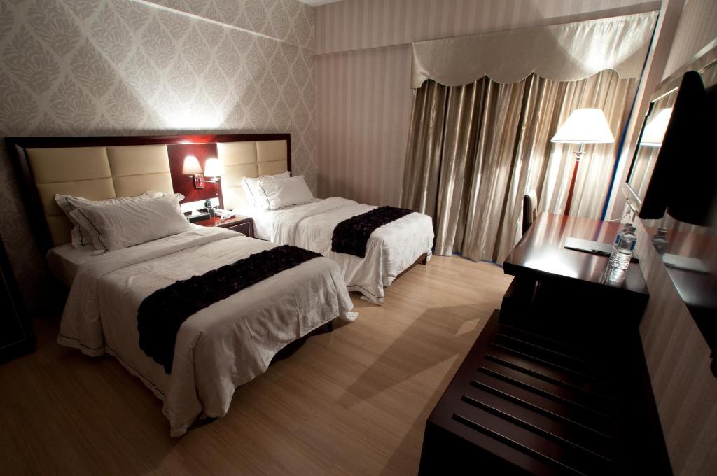 Postel nebo postele na pokoji v ubytování Pariss Hotel