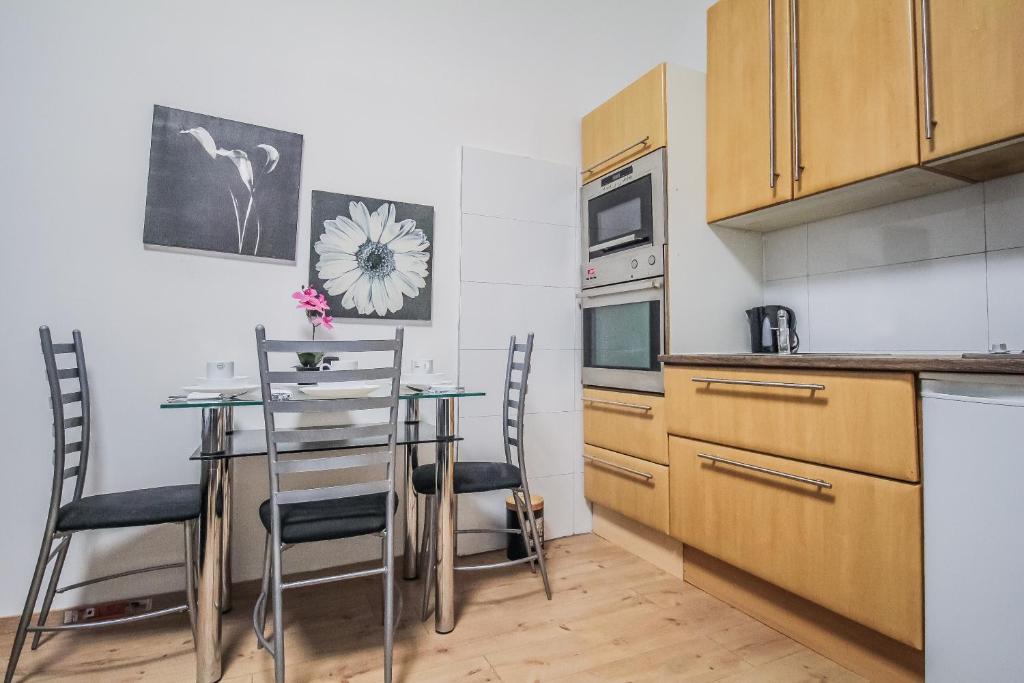 a kitchen with a table and chairs in a room at Comfort Quad room HN in Vienna