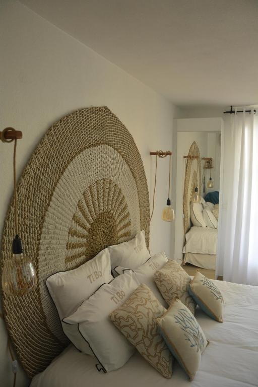 una camera da letto con un grande letto in vimini con cuscini di Studio TI BO 4 a Saint Martin