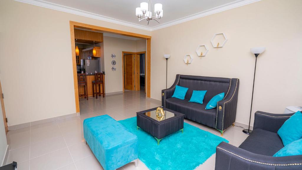 a living room with a couch and a blue rug at Sky Blue in Jarabacoa