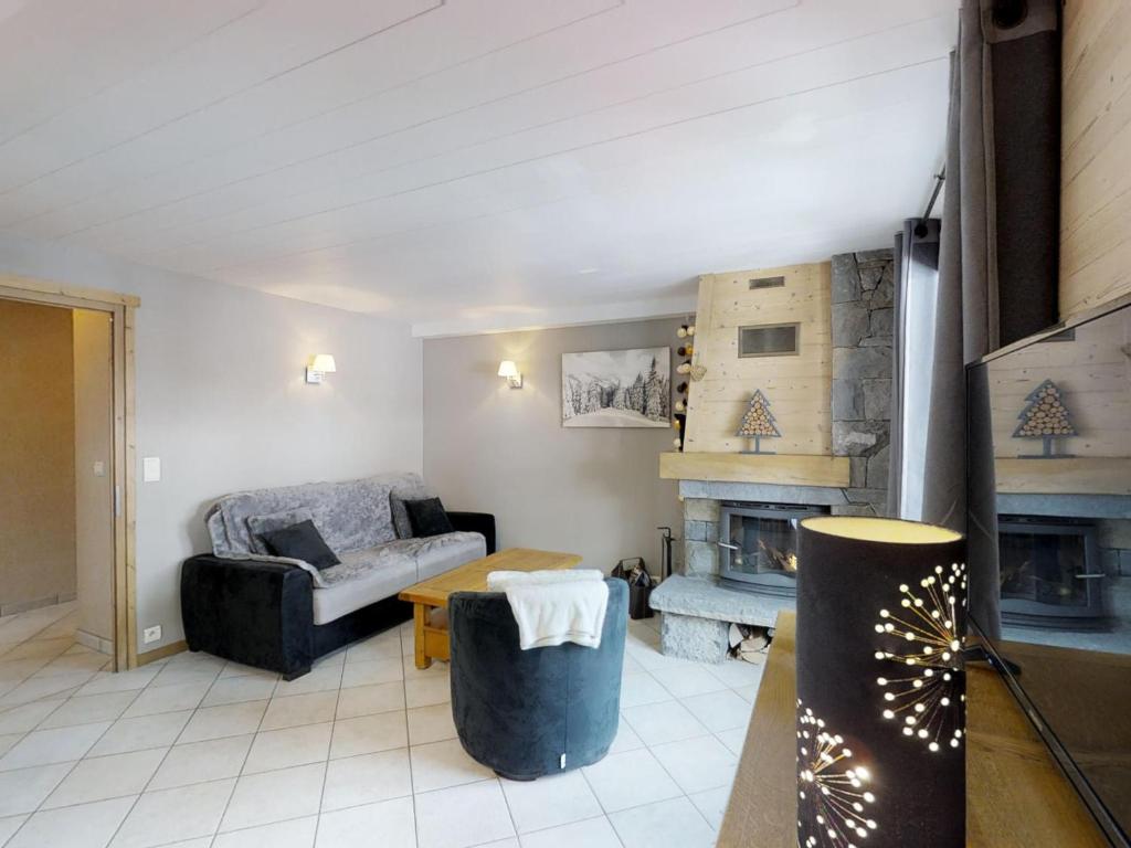 a living room with a couch and a fireplace at Appartement Le Grand-Bornand, 3 pièces, 4 personnes - FR-1-467-55 in Le Grand-Bornand