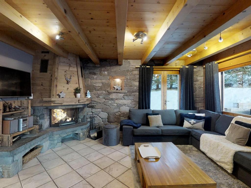 a living room with a couch and a fireplace at Chalet Le Grand-Bornand, 6 pièces, 11 personnes - FR-1-467-58 in Le Grand-Bornand