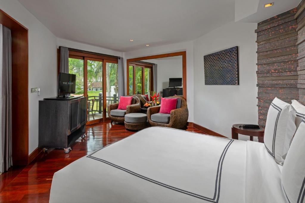 a bedroom with a bed and a living room at The Slate, Phuket in Nai Yang Beach