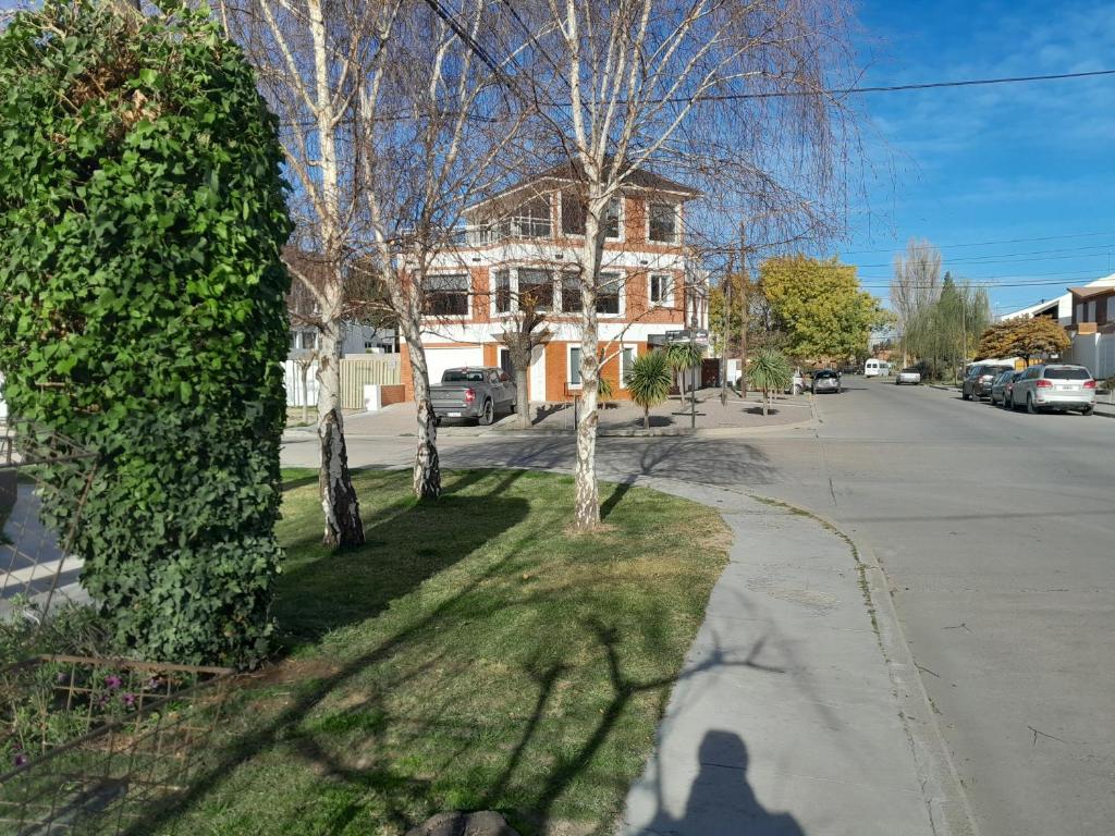 a shadow of a person walking down a street at MAILAR d1 in Puerto Madryn