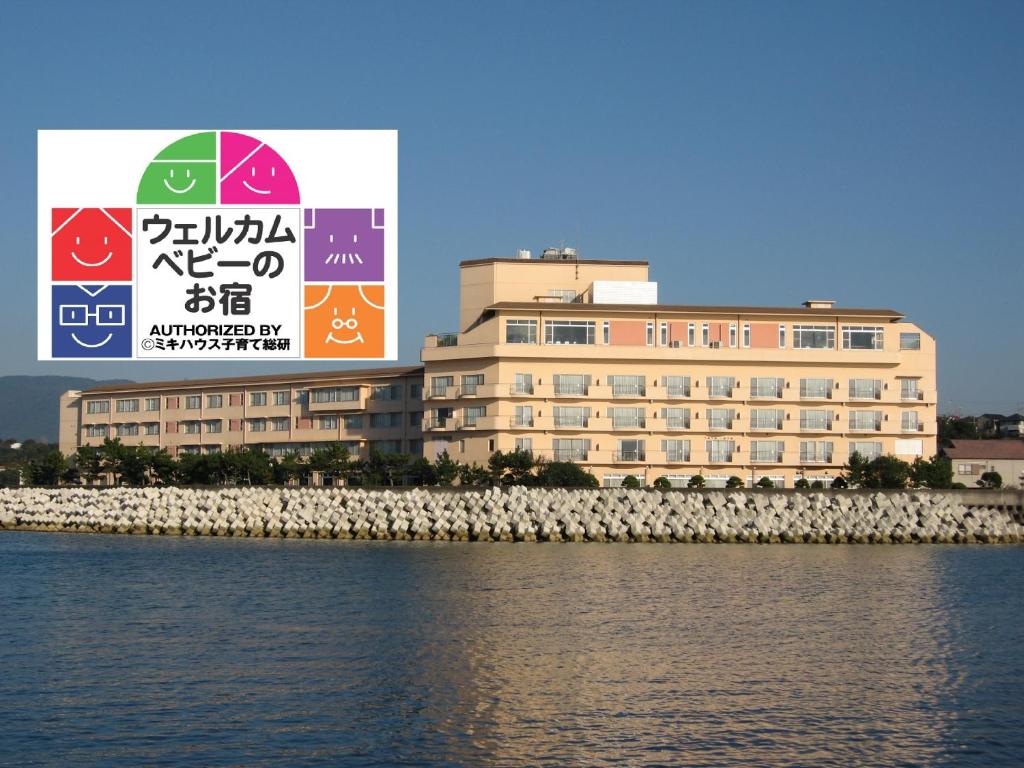 a large building next to a body of water at KAMENOI HOTEL Kii-Tanabe in Tanabe