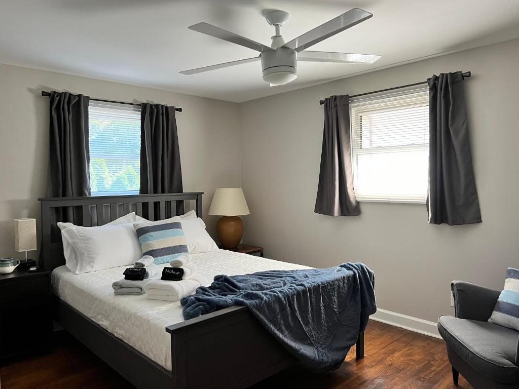 a bedroom with a bed with a ceiling fan at River's Rest in Columbus