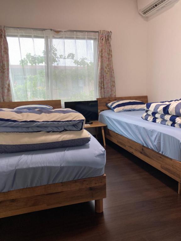 Postel nebo postele na pokoji v ubytování Guest House Hinode