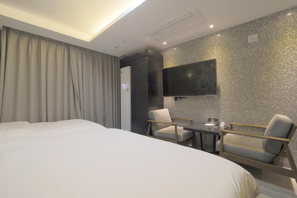Postel nebo postele na pokoji v ubytování HOTEL YUNA Business