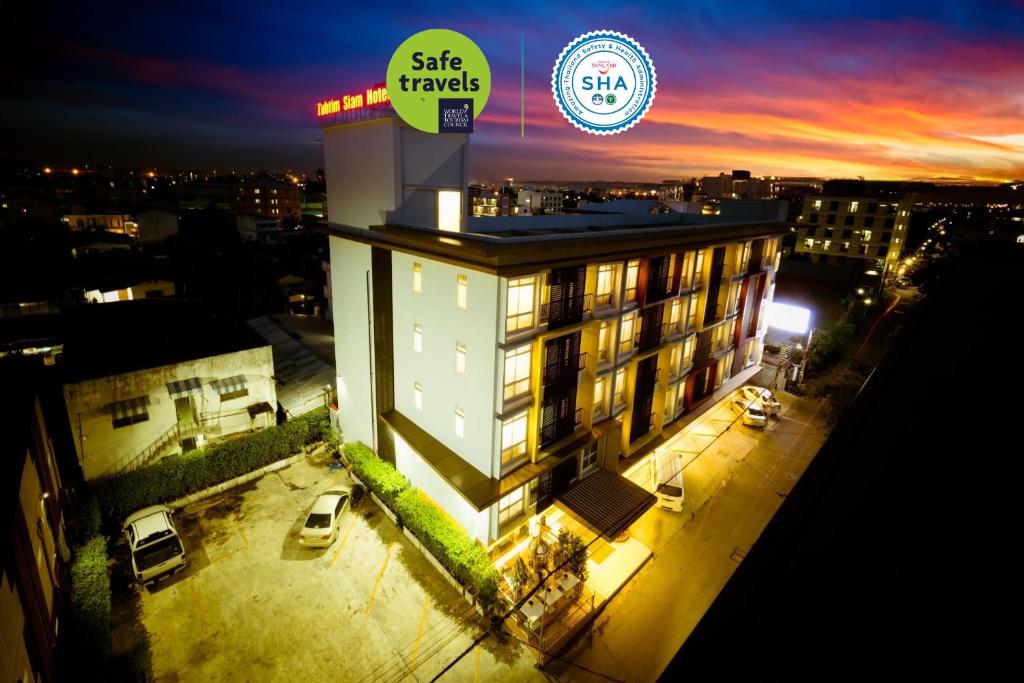 a building with a sign on top of it at night at Tubtim Siam Suvarnabhumi Hotel in Bang Phli