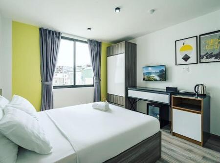 Dormitorio con cama, escritorio y teclado en AILEN BOUTIQUE HOTEL en Ho Chi Minh