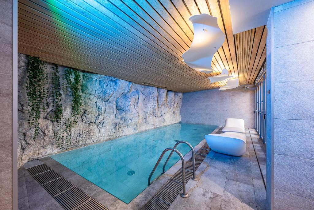 uma casa de banho com uma piscina com uma banheira e um WC em Hôtel B55 em Paris