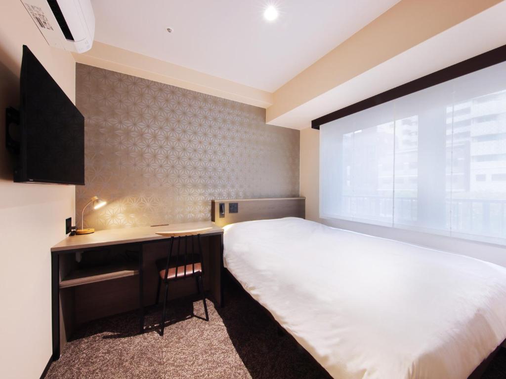 Postel nebo postele na pokoji v ubytování Hotel SUI Kobe Sannomiya by ABEST