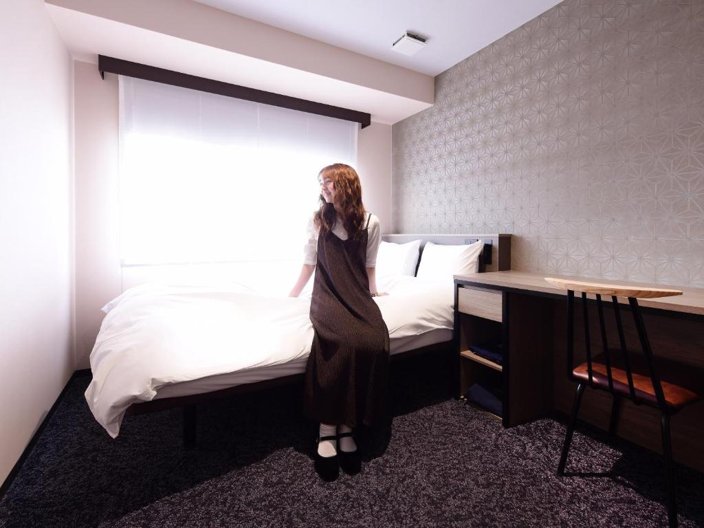 Postel nebo postele na pokoji v ubytování Hotel SUI Kobe Sannomiya by ABEST