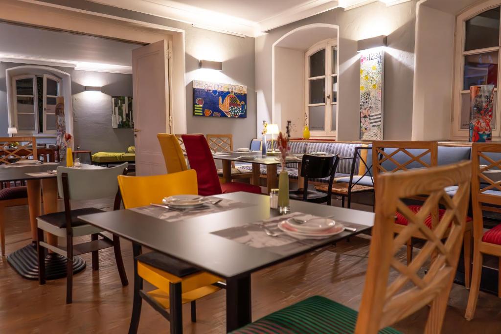 a dining room with tables and chairs at Hotel Bergbauer in Neuburg an der Donau