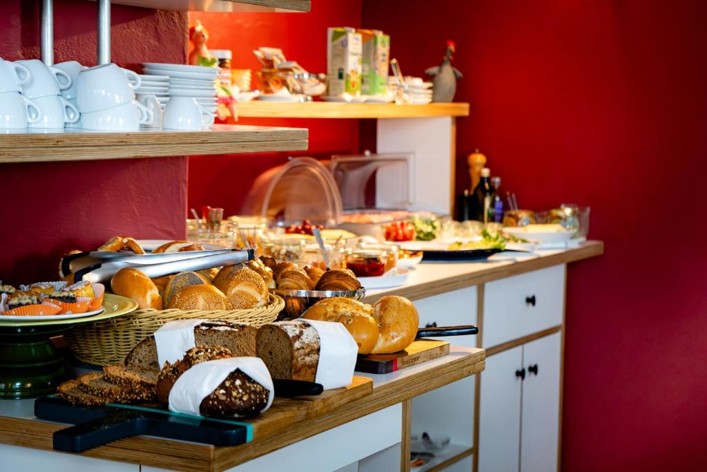a buffet of bread and pastries on a table at Hotel Bergbauer in Neuburg an der Donau