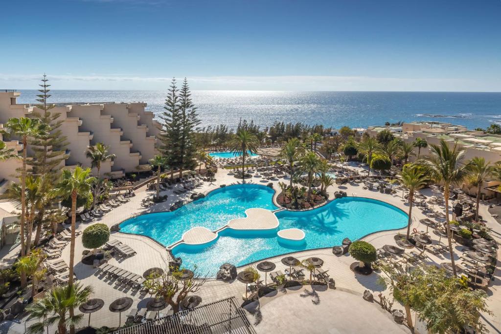 an aerial view of a resort with a pool and the ocean at Barceló Lanzarote Active Resort in Costa Teguise