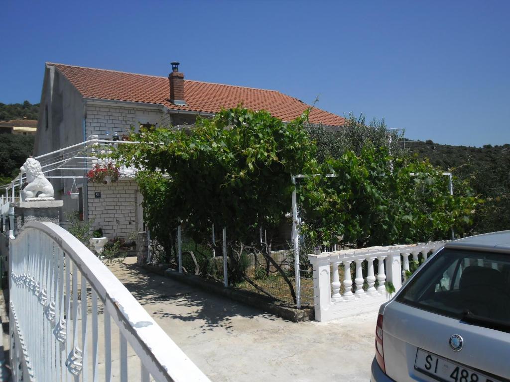 une voiture garée sur un pont à côté d'une maison dans l'établissement Apartmens Zara, à Šibenik