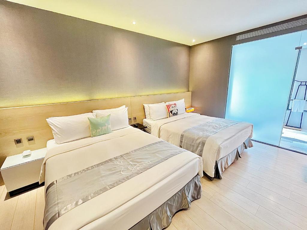 Postel nebo postele na pokoji v ubytování Vasty Jiaoxi Hotel