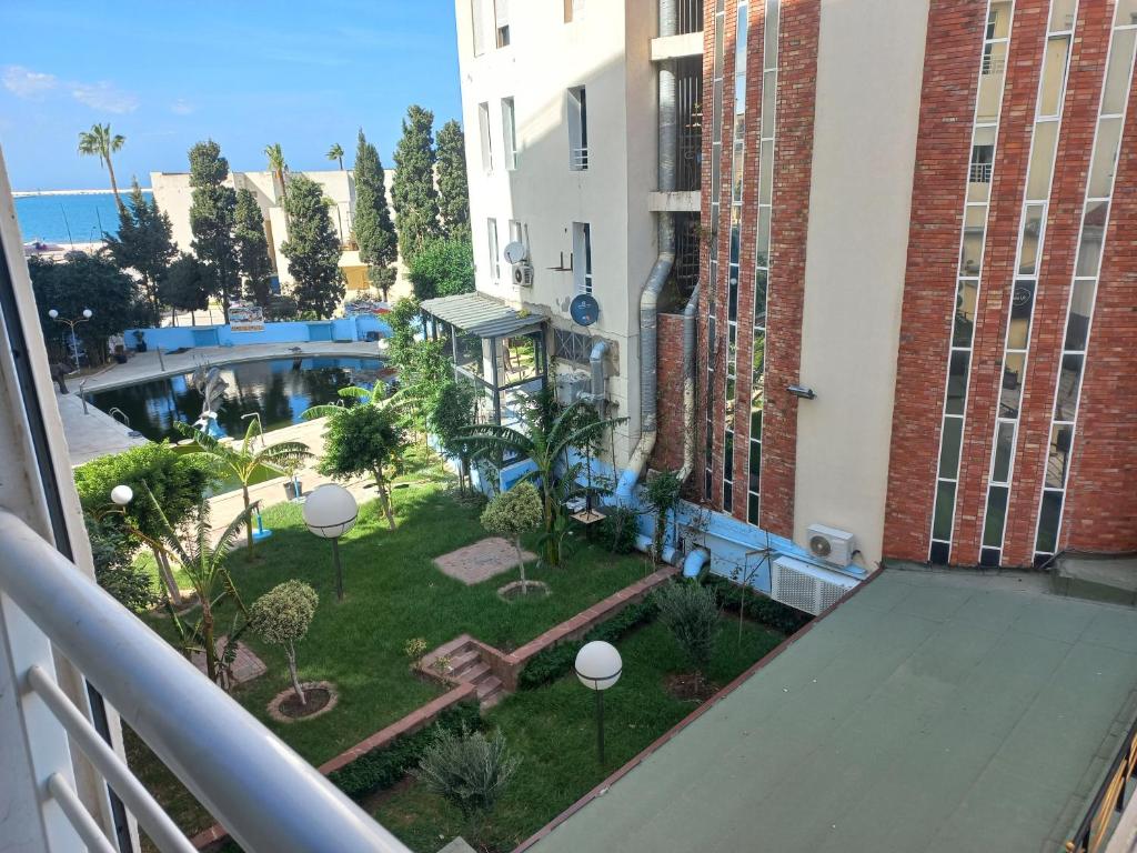 an apartment balcony with a view of a courtyard at Appartement Familia Corniche Malabata Tanger in Tangier