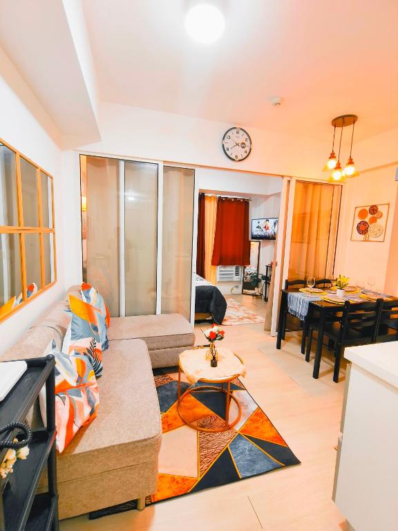 ein Wohnzimmer mit einem Sofa und einem Tisch in der Unterkunft Azure Stay by Marjorenz in Manila