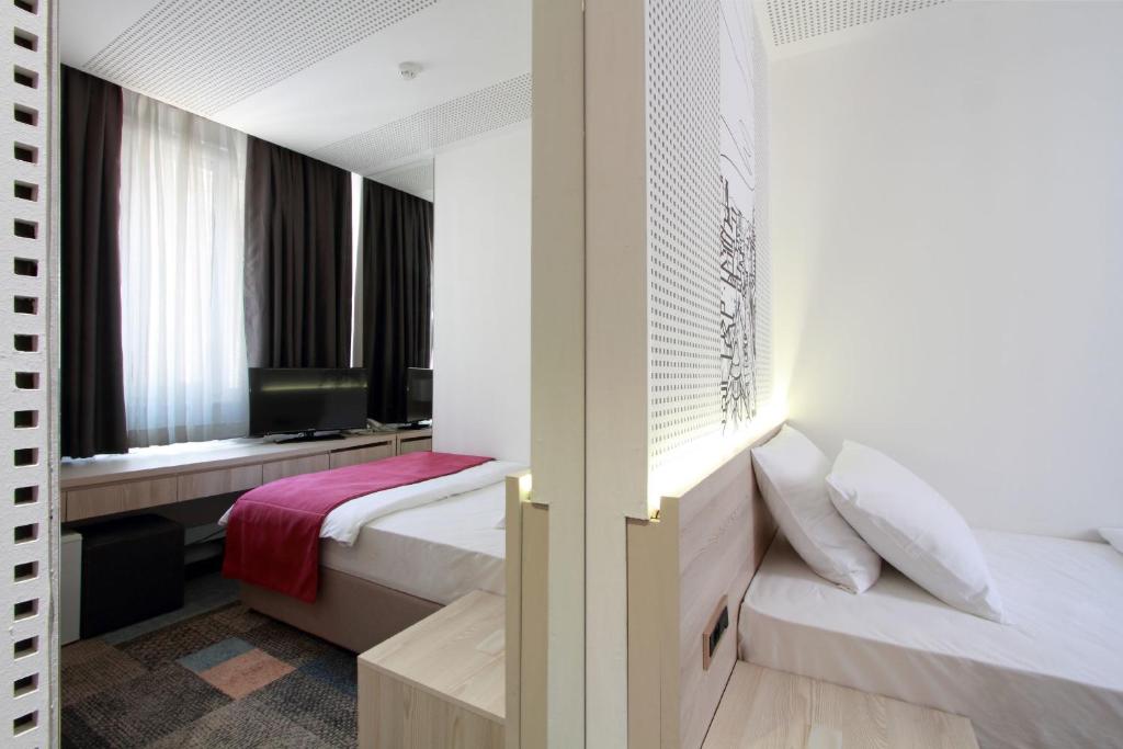 Postel nebo postele na pokoji v ubytování Hotel Cosmopolit