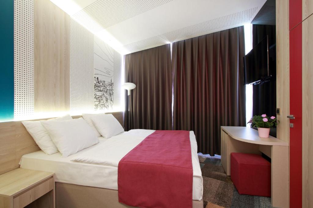 Postel nebo postele na pokoji v ubytování Hotel Cosmopolit