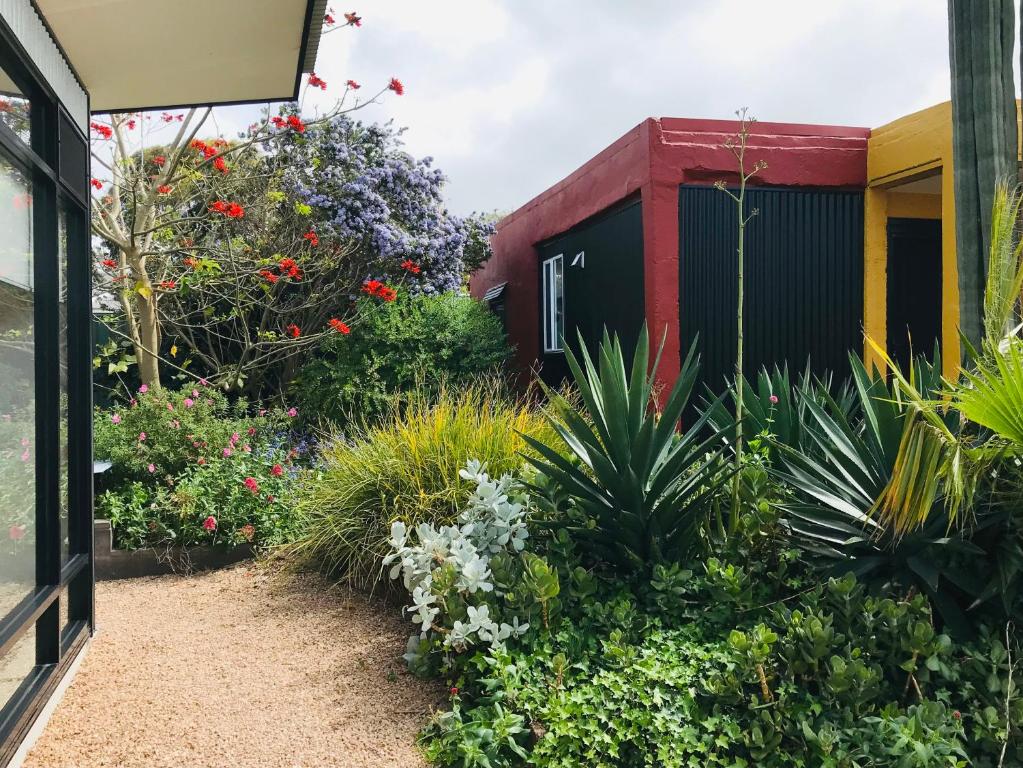 a garden with flowers and plants in front of a building at Sinclair Cottage in Port Lincoln