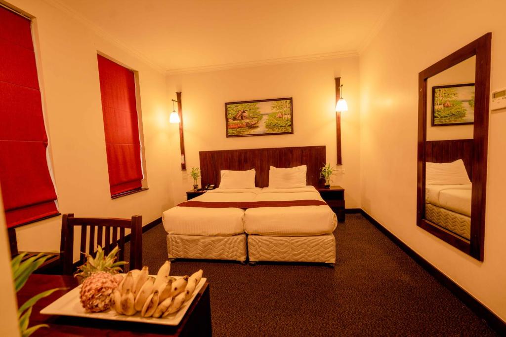 Postel nebo postele na pokoji v ubytování Hotel Nippon Colombo