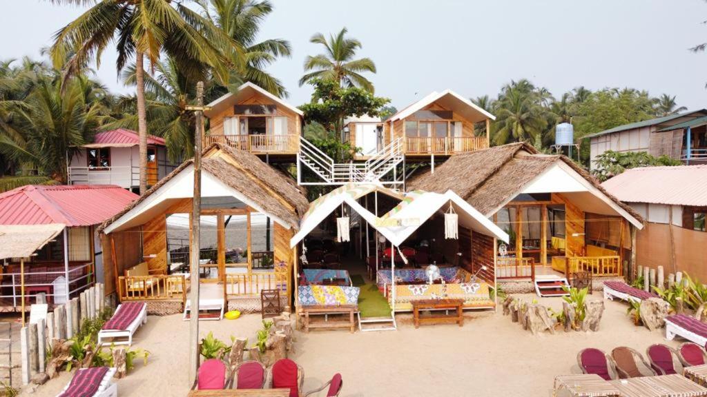 a resort with a lot of tables and chairs at DucknChill-Agonda in Agonda