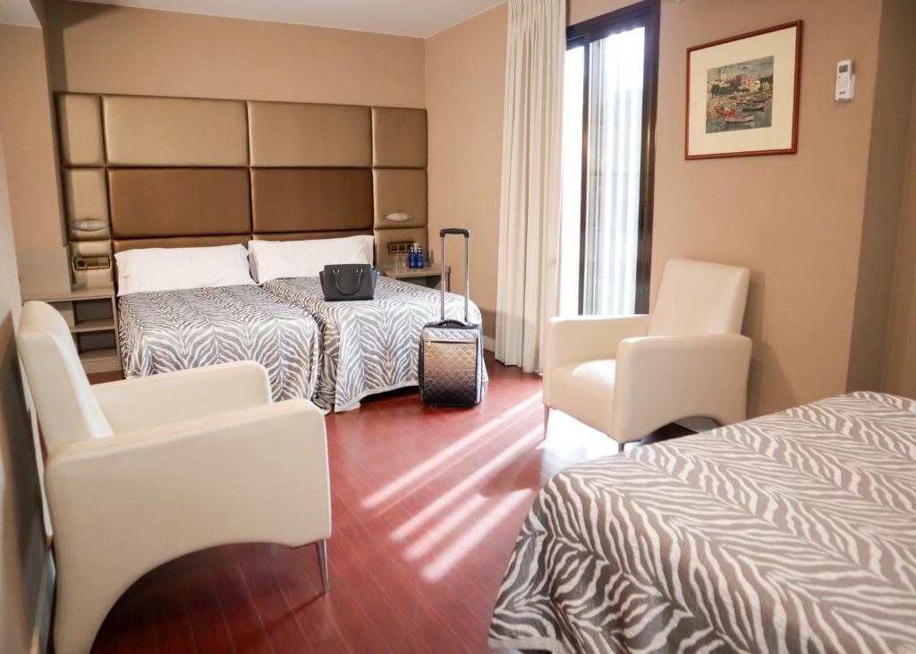Postel nebo postele na pokoji v ubytování Hotel Benetusser
