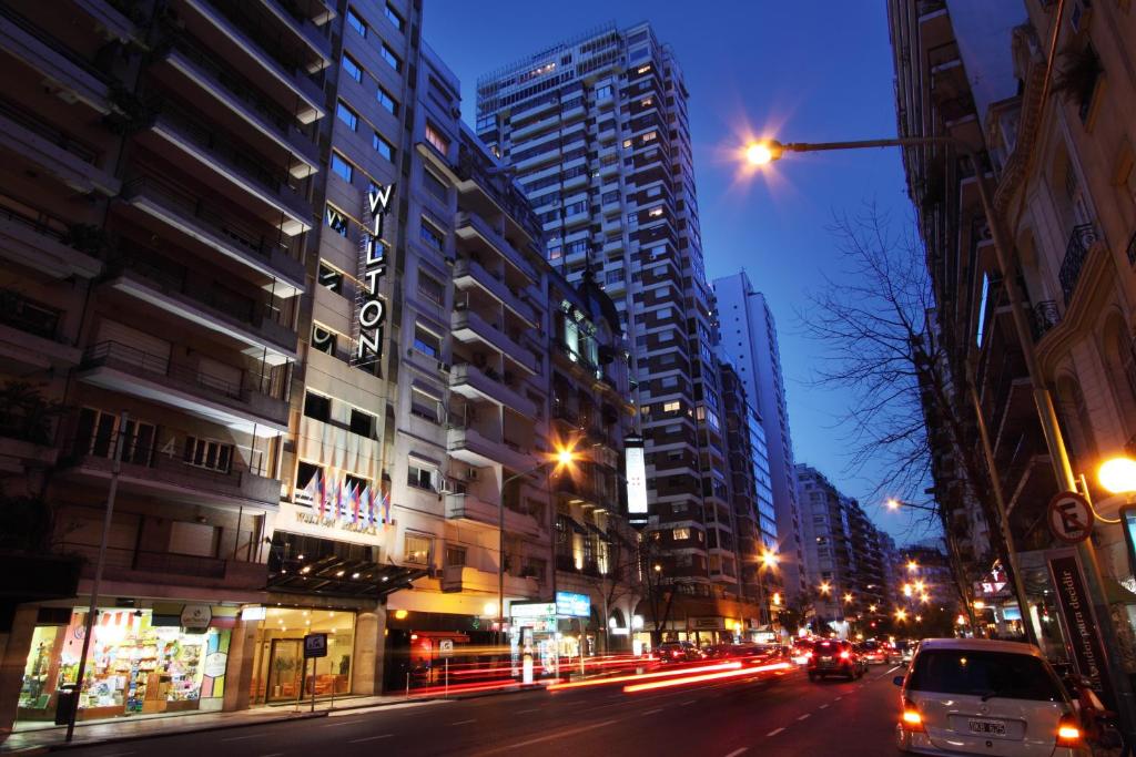 a city street at night with cars and buildings at Wilton Hotel Buenos Aires in Buenos Aires