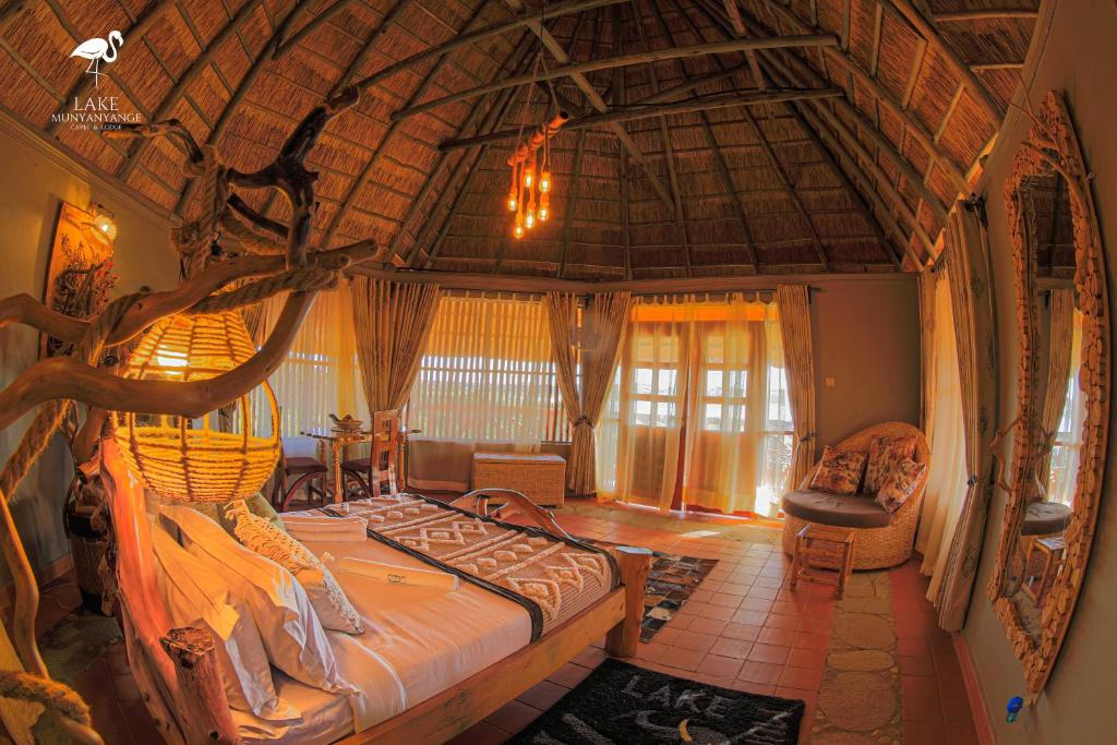 a bedroom with a large bed in a room at Lake Munyanyange Caves Lodge in Kasese