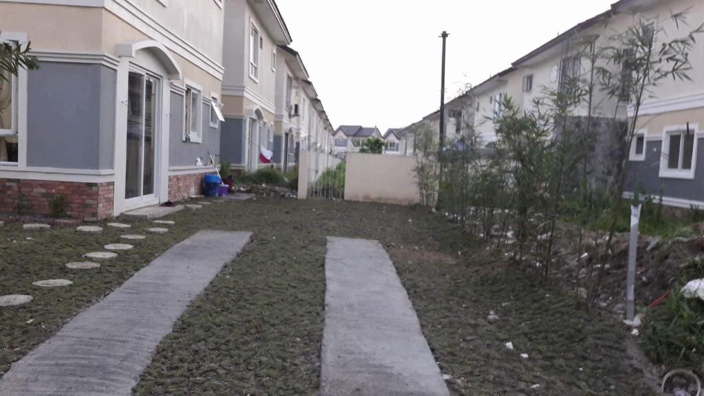 a backyard of a house with a walkway at Vacation home in Lancaster new city Cavite Philippines in General Trias