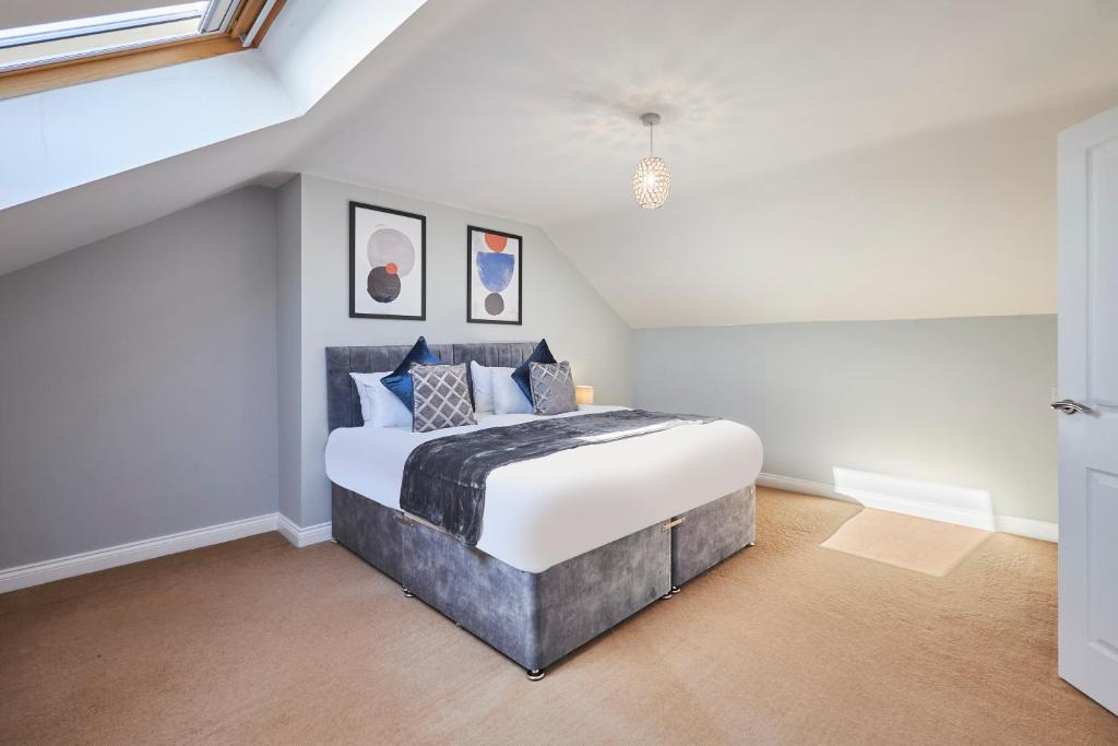 a bedroom with a large bed in a attic at Host & Stay - Tibshelf House in Tibshelf