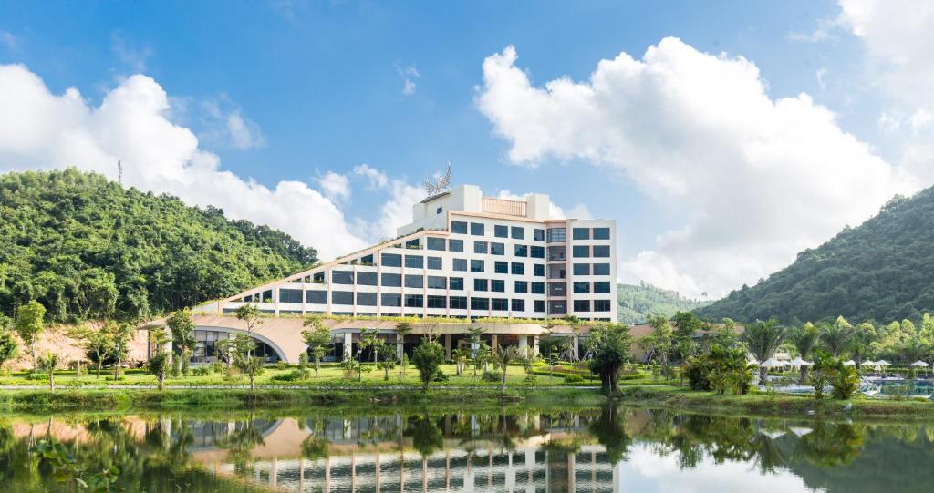 a large building next to a body of water at Muong Thanh Luxury Dien Lam in Diễn Châu