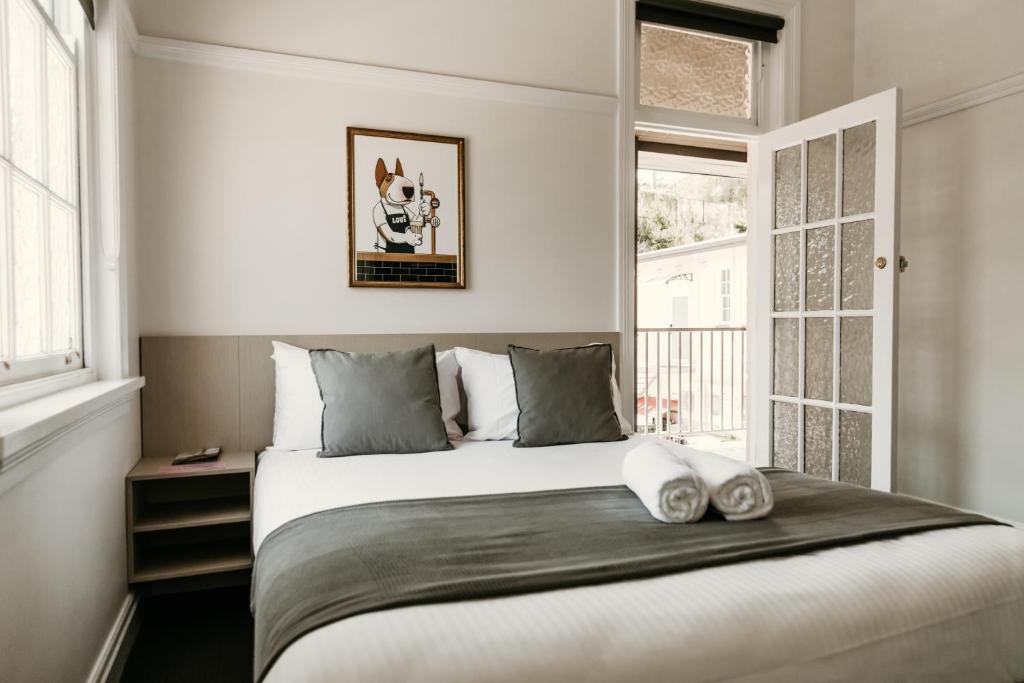 a bedroom with a large bed and a window at The Imperial Hotel in Murwillumbah