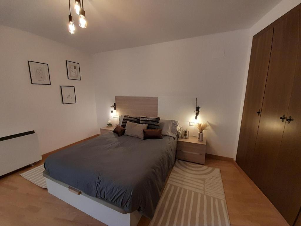 een slaapkamer met een groot bed en 2 lampen bij Los ojos de Norah boutique in Mora de Rubielos