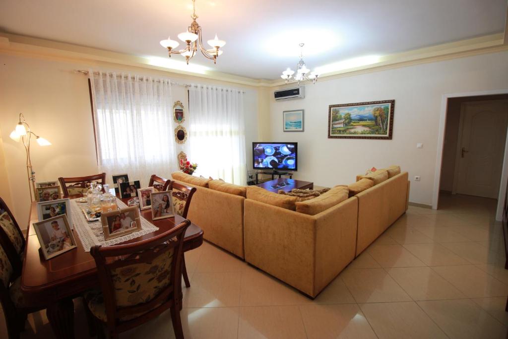 a living room with a couch and a table at Elida Apartments in Gjirokastër