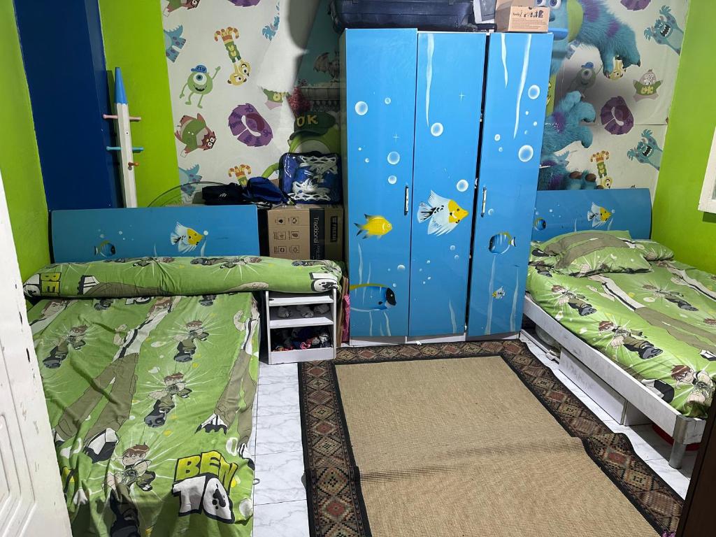 a bedroom with two bunk beds and a wall with nemo at شقه بحديقه رائعه in Cairo