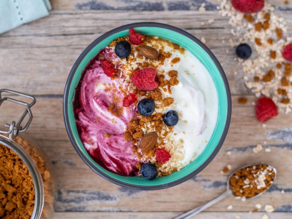 a bowl of yogurt with berries and granola at ibis Styles Paris Charles de Gaulle Airport in Roissy-en-France