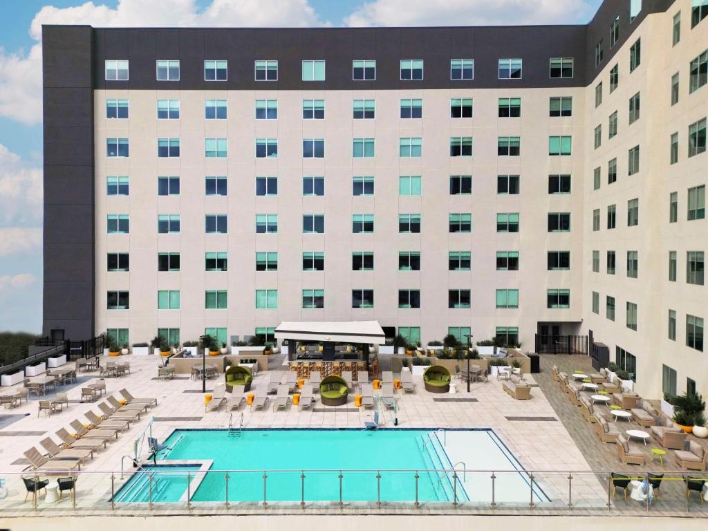 a hotel with a pool in front of a building at Hyatt Place Houston Medical Center in Houston
