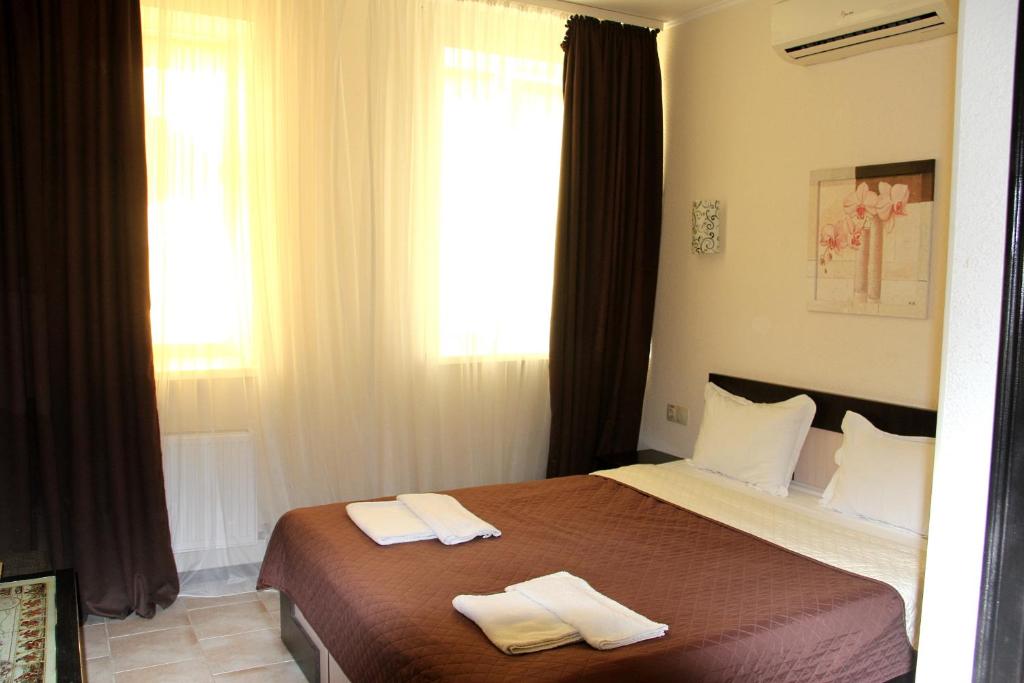 Postel nebo postele na pokoji v ubytování Breeze Hotel