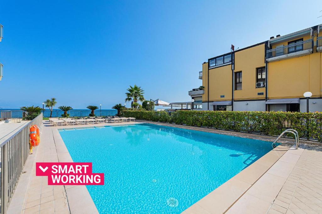 a swimming pool in front of a building at Residenza Miralago by Wonderful Italy in Desenzano del Garda