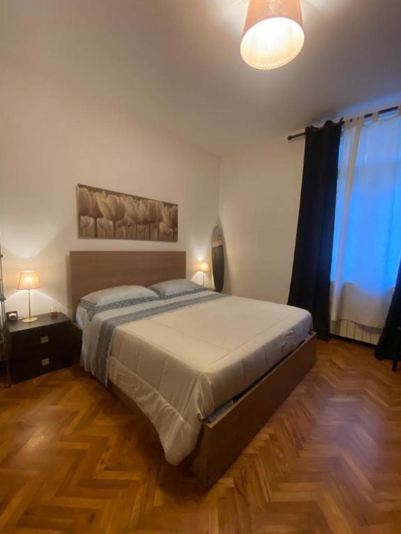 a bedroom with a large bed and a large window at Casa Xenia in Trieste