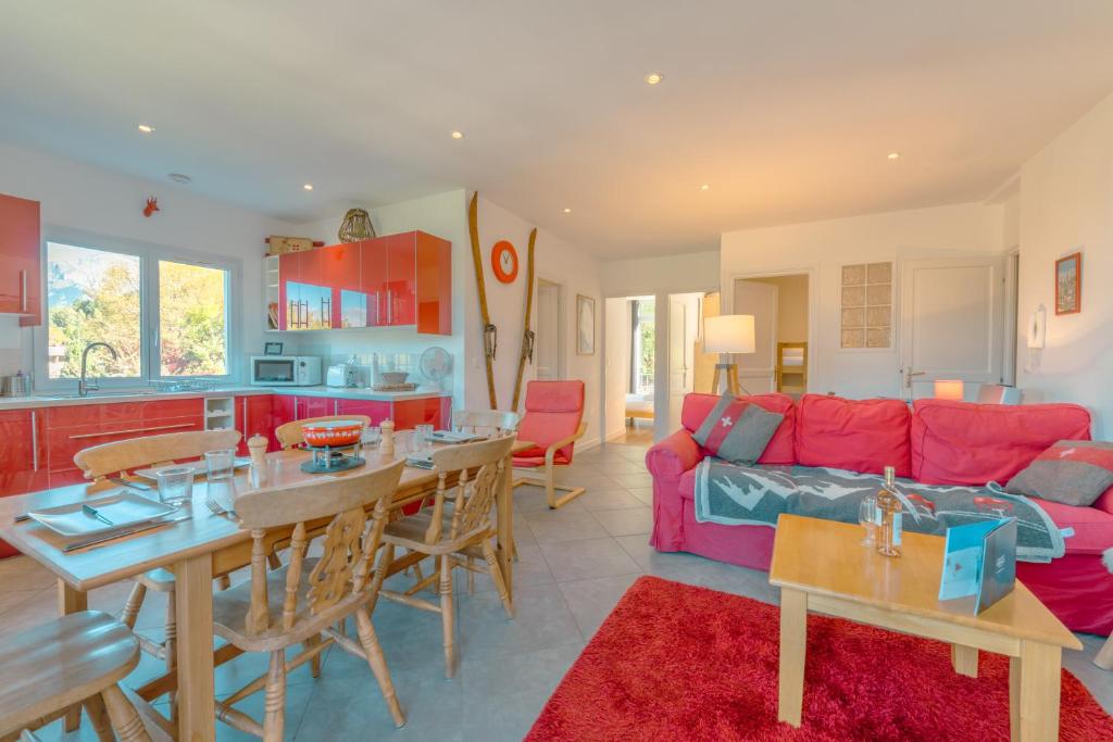 un salon avec un canapé rouge et une table dans l'établissement Appartement Etchea- 202 - Happy Rentals, à Saint-Gervais-les-Bains