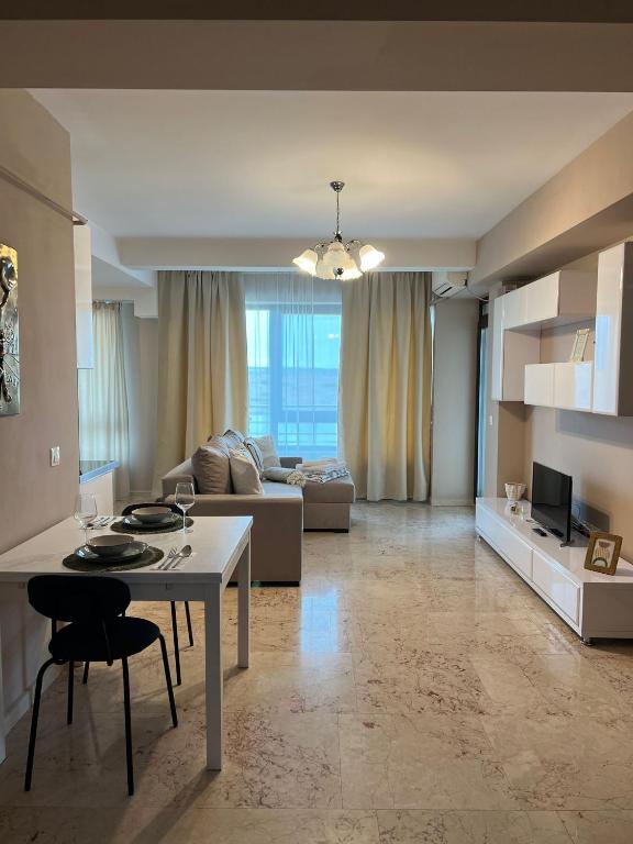 a living room with a table and a couch at Copou Central Linden Suite in Iaşi