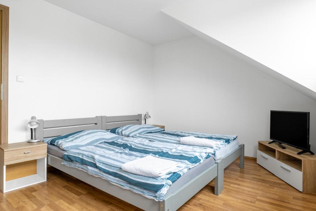 Postel nebo postele na pokoji v ubytování Apartmány Borská Plzeň