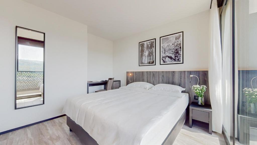 Postel nebo postele na pokoji v ubytování THREE POINT Apartments