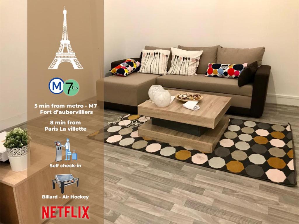a living room with a couch and a coffee table at Grand F2 60m2 Paris 19ème - La Villette & Stade de France in Aubervilliers